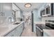 Modern kitchen with white quartz countertops, stainless steel appliances, and plenty of cabinet space at 6035 Manasota Key Rd, Englewood, FL 34223