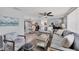 Cozy living room with connected dining room area, wood floors, and neutral tones at 6035 Manasota Key Rd, Englewood, FL 34223