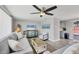 Spacious living room with gray couches, wood-look floors, and beach themed decor at 6035 Manasota Key Rd, Englewood, FL 34223