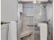 Modern bathroom shower featuring grey tiled walls, glass enclosure, and convenient built-in bench at 6035 Manasota Key Rd, Englewood, FL 34223
