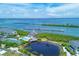 Fantastic aerial view showcasing community amenities: pool, tennis court, and docks on the water at 6040 Boca Grande Cswy # A2, Boca Grande, FL 33921