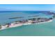 Stunning aerial view of a coastal property featuring multiple residences, boat docks, and beautiful turquoise water at 6040 Boca Grande Cswy # A2, Boca Grande, FL 33921