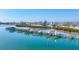 Aerial view of the marina showcasing boat slips, luxurious condos, pool, and serene waterfront location on a sunny day at 6040 Boca Grande Cswy # A2, Boca Grande, FL 33921