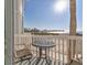 A lovely outdoor balcony featuring a wrought iron table and chairs, overlooks the beautiful beach waterfront at 6040 Boca Grande Cswy # A2, Boca Grande, FL 33921