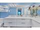 The bathroom features a white dual sink vanity, pendant lighting, and a large mirror to create an open feel at 6040 Boca Grande Cswy # A2, Boca Grande, FL 33921