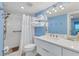 A bright bathroom features a white vanity, shower with white tile surround, and a storage shelf for fresh towels at 6040 Boca Grande Cswy # A2, Boca Grande, FL 33921