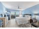 Cozy bedroom with a large window, white bedding, light blue walls, and dark wood furniture at 6040 Boca Grande Cswy # A2, Boca Grande, FL 33921
