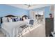 A well-lit bedroom with two beds, seaside-themed decor, and a sliding glass door to a private balcony at 6040 Boca Grande Cswy # A2, Boca Grande, FL 33921