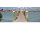 View down a long wooden boat dock extending into the ocean, offering direct access to boating and water activities at 6040 Boca Grande Cswy # A2, Boca Grande, FL 33921