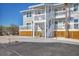 Building exterior showcasing balconies and white stairs, blending modern design with a coastal environment at 6040 Boca Grande Cswy # A2, Boca Grande, FL 33921