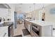 Contemporary kitchen with stainless steel appliances, a large island, and an open concept design leading to the dining area at 6040 Boca Grande Cswy # A2, Boca Grande, FL 33921