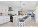 Open concept kitchen featuring a spacious island with bar stools and stainless steel appliances with water view at 6040 Boca Grande Cswy # A2, Boca Grande, FL 33921