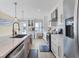 Well-lit kitchen featuring quartz countertops, stainless steel appliances, and a view of the outside at 6040 Boca Grande Cswy # A2, Boca Grande, FL 33921