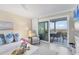 Comfortable living area featuring a sliding glass door to an outdoor balcony and picturesque ocean scenery at 6040 Boca Grande Cswy # A2, Boca Grande, FL 33921