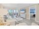 Tastefully decorated living space with an open layout to a balcony and view into a comfortably furnished bedroom at 6040 Boca Grande Cswy # A2, Boca Grande, FL 33921