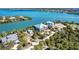 Aerial shot showcases waterfront homes, vibrant landscaping, and serene water views at 62 Tarpon Way, Placida, FL 33946