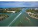 Aerial view of boats cruising on calm water, surrounded by lush vegetation and coastal views at 62 Tarpon Way, Placida, FL 33946