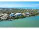 An aerial view shows the waterfront home and the dock, highlighting its unique waterfront lifestyle at 62 Tarpon Way, Placida, FL 33946