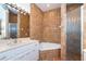 Bathroom with tiled walls, a shower with glass doors, bathtub, and a vanity with ample counter space at 62 Tarpon Way, Placida, FL 33946