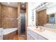 Bathroom featuring tiled walls, a bathtub, a separate shower, and a vanity with ample counter space at 62 Tarpon Way, Placida, FL 33946
