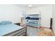 Comfortable bedroom features bunk beds, twin bed, terracotta tile flooring, and ample natural light at 62 Tarpon Way, Placida, FL 33946