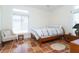 Bright bedroom featuring a bed, side table, tile floors and large windows with blinds at 62 Tarpon Way, Placida, FL 33946