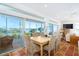 Bright dining room featuring large windows overlooking waterfront views and seating for six at 62 Tarpon Way, Placida, FL 33946