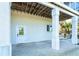 View of exterior with under house space on a gravel base with a white door entrance at 62 Tarpon Way, Placida, FL 33946