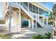 Exterior view of the home with white stairs and beachy feel at 62 Tarpon Way, Placida, FL 33946