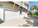 Exterior shot of a home featuring an attached garage with an upper deck at 62 Tarpon Way, Placida, FL 33946