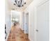 Hallway featuring terracotta tile flooring, chandelier, and access to the living spaces with lots of natural light at 62 Tarpon Way, Placida, FL 33946