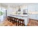 Spacious kitchen with seating at the island, granite countertops, and bright white cabinetry at 62 Tarpon Way, Placida, FL 33946