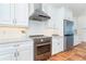 Close up shot of kitchen with granite countertops, stainless steel appliances, and white cabinetry at 62 Tarpon Way, Placida, FL 33946