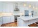 Well-equipped kitchen with modern stainless steel appliances, granite countertops, and white cabinetry at 62 Tarpon Way, Placida, FL 33946