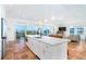 Spacious kitchen featuring a large island, stainless steel appliances, and views of the living area at 62 Tarpon Way, Placida, FL 33946