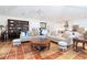 Comfortable living room with tile flooring, seating, and a view into the bright white kitchen at 62 Tarpon Way, Placida, FL 33946