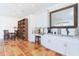 Bright office space with a desk, sink, cabinetry, decorative mirror and shelving for storage at 62 Tarpon Way, Placida, FL 33946