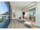 Relaxing screened-in porch with seating area, slider doors, and serene water views at 62 Tarpon Way, Placida, FL 33946
