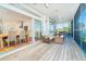 Open porch connected to the kitchen featuring wooden floors and outdoor seating at 62 Tarpon Way, Placida, FL 33946
