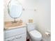 Powder room featuring a single sink vanity and a toilet with neutral walls at 62 Tarpon Way, Placida, FL 33946