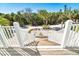 Exterior stairs connect the home to the outdoors, surrounded by tropical landscaping at 62 Tarpon Way, Placida, FL 33946