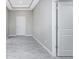 Hallway with tray ceiling, doors, and wood-look tile at 6602 David Blvd, Port Charlotte, FL 33981