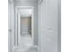 Hallway with an open doorway showing bathroom fixtures at 6602 David Blvd, Port Charlotte, FL 33981