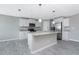 Stylish kitchen with white cabinets, granite countertops, stainless steel appliances, and central island at 6602 David Blvd, Port Charlotte, FL 33981