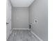 Functional laundry room featuring neutral walls and wood-look flooring at 6602 David Blvd, Port Charlotte, FL 33981