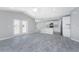 Open-concept living area with gray wood-look floors, seamlessly connected to a modern kitchen at 6602 David Blvd, Port Charlotte, FL 33981