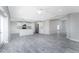 Bright, open-concept living area connects a modern kitchen and living room with gray wood-look flooring at 6602 David Blvd, Port Charlotte, FL 33981