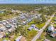 This aerial shows a quaint neighborhood with lush trees and cozy single-Gathering homes at 698 & West W Perry St, Englewood, FL 34223