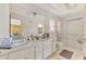 Bright bathroom featuring a double vanity, walk-in shower, and functional layout at 698 & West W Perry St, Englewood, FL 34223