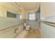 Tiled bathroom featuring vintage fixtures and lots of natural light at 698 & West W Perry St, Englewood, FL 34223
